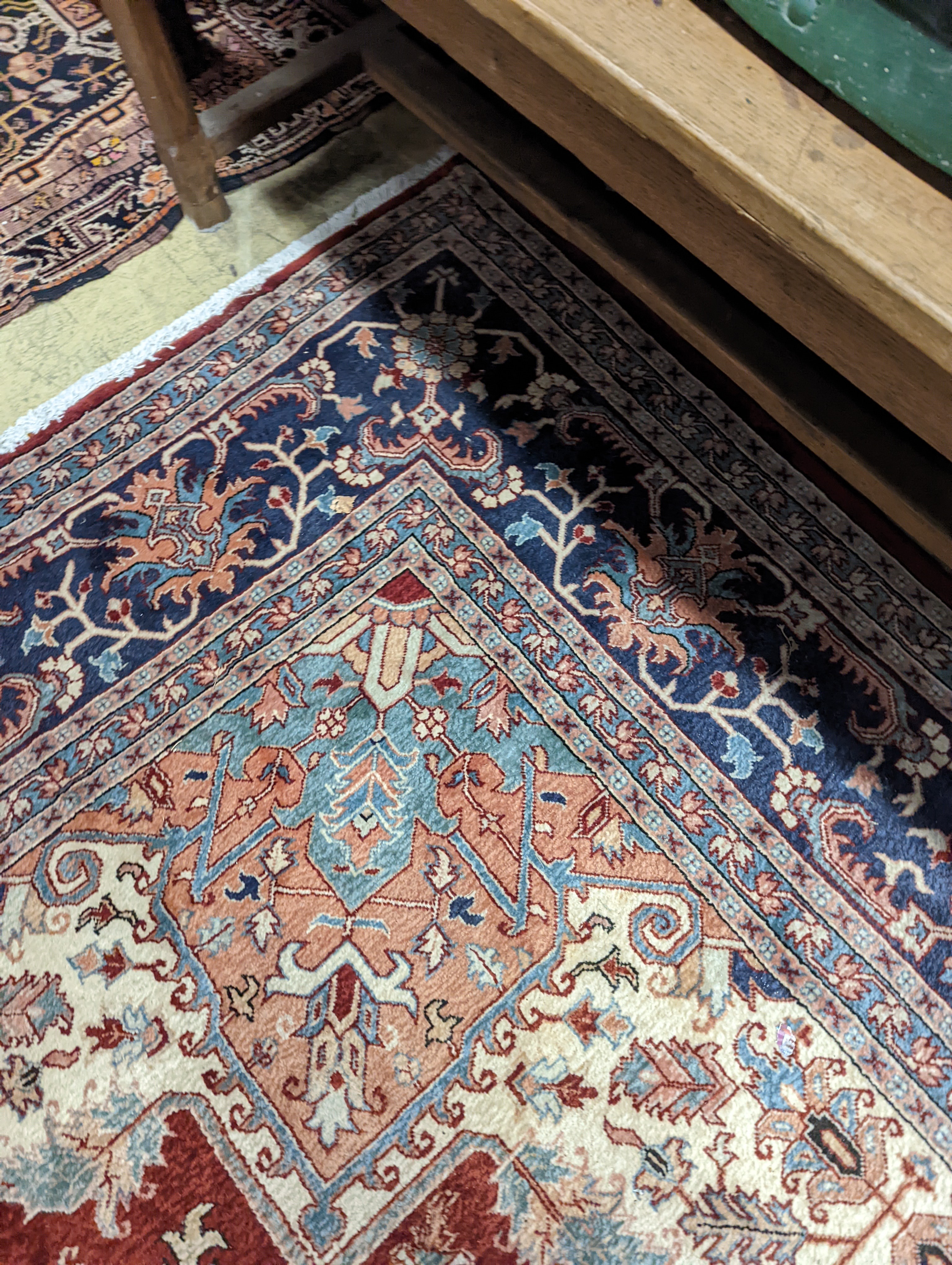 A large Caucasian style red ground carpet, 460 x 330cm